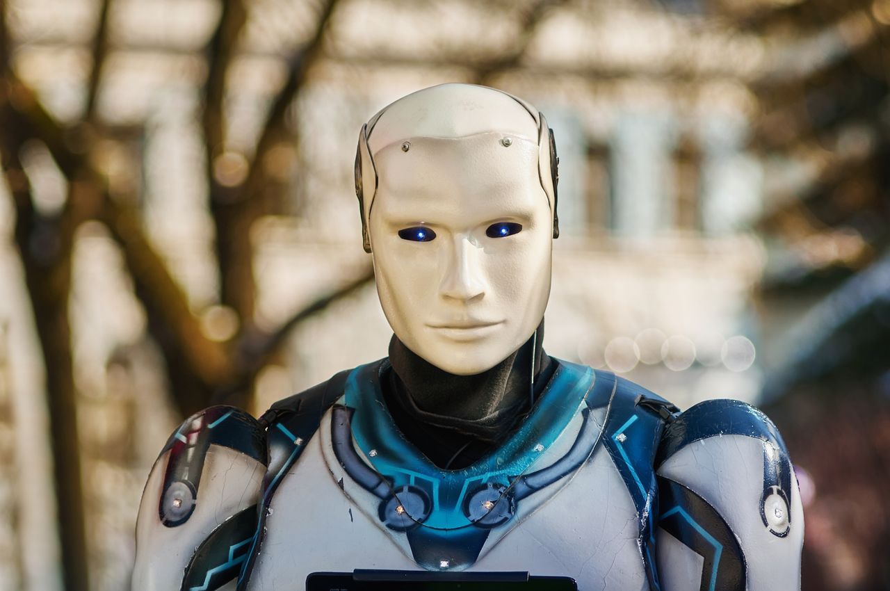 Services Close-up of a humanoid robot with a futuristic design posing outdoors.
